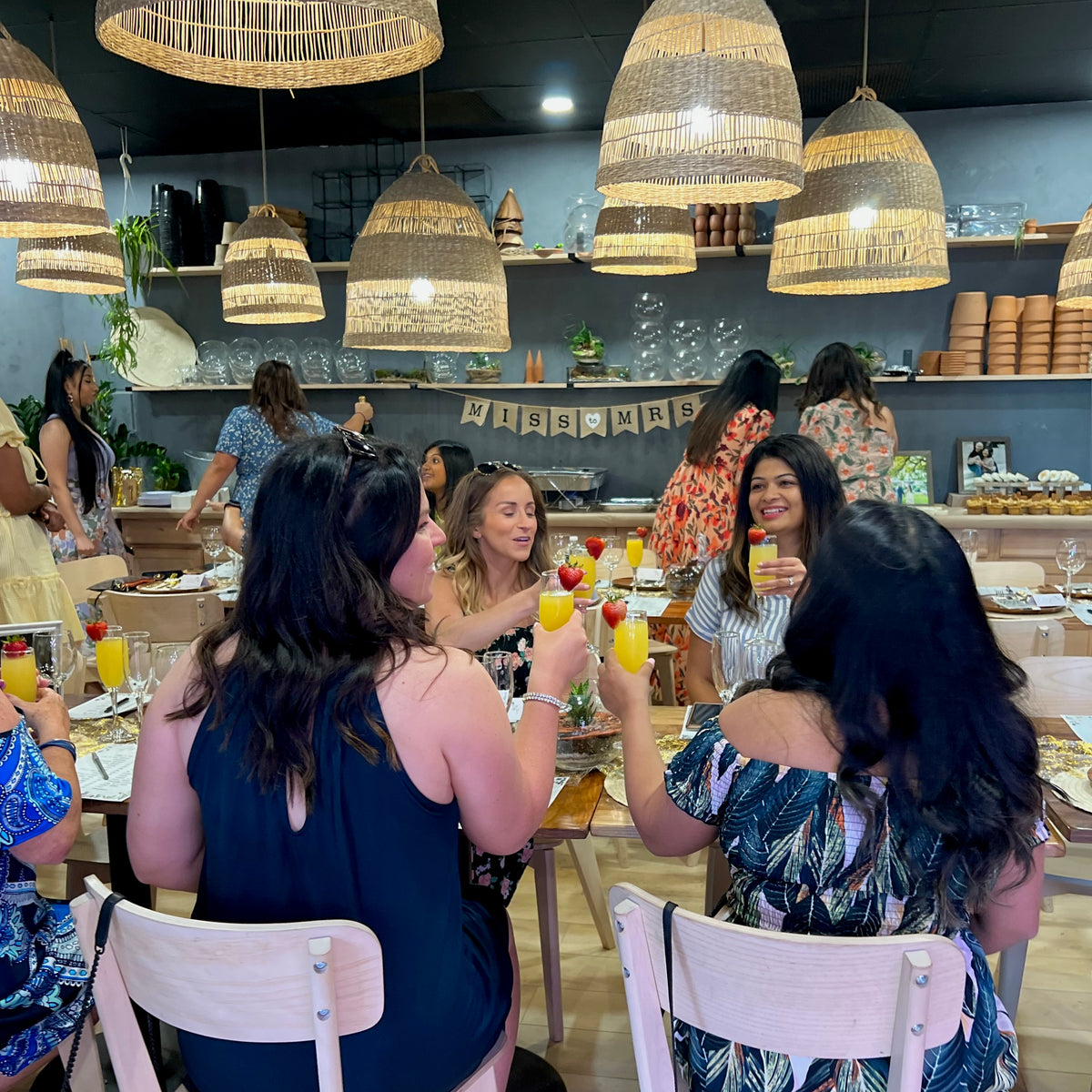 guests toasting at a bridal shower at spotted leaf plant company in somerville, nj, terrariums on the table